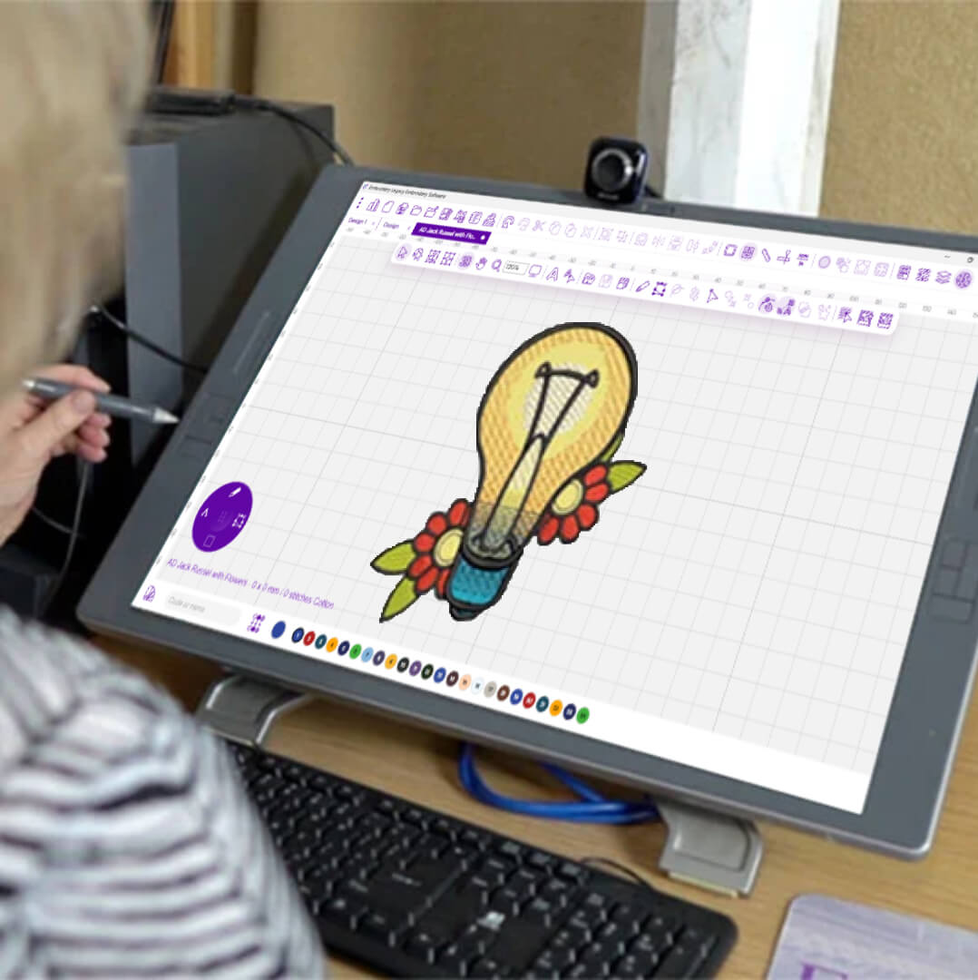 embroidery-digitizing-software-design-tablet | Embroidery Legacy A lady embroidery digitizing a lightbulb embroidery design with flowers on a computer screen