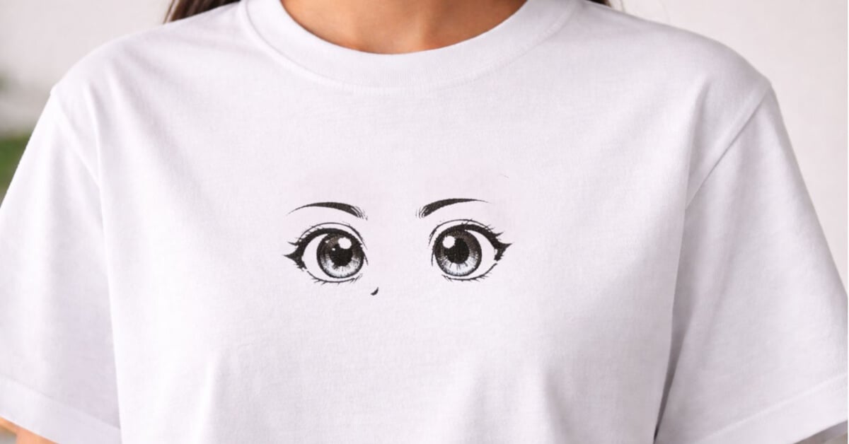 Kawaii anime embroidery design featuring simple, expressive eyes stitched on a white t-shirt
