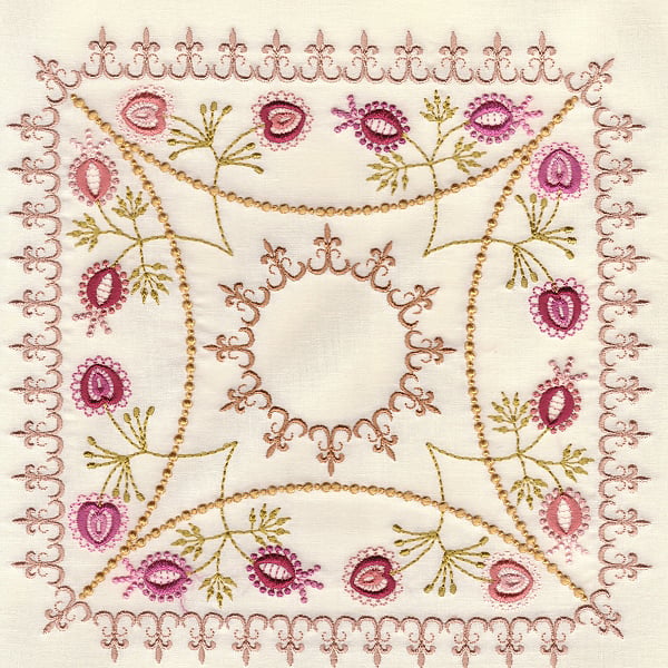 Decorative embroidered square fabric with pink and gold flowers and vine borders around a central circular motif.