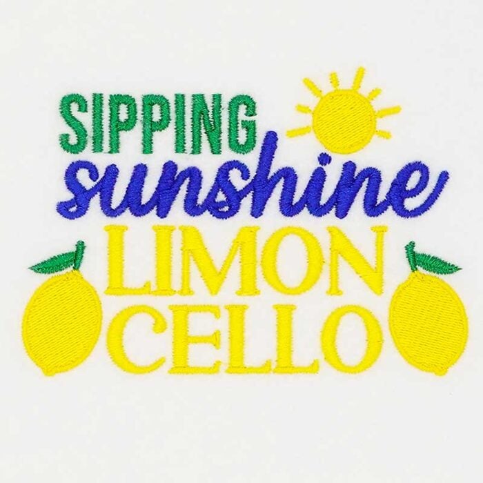 SDMS_SippingSunshine | Embroidery Legacy Embroidery design reading 'Sipping sunshine' with lemon imagery and 'LEMON CELLO' in yellow text, on white fabric.