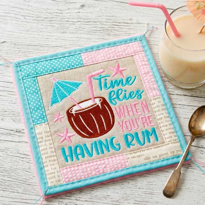 SDSB_TimeFliesRum_Coaster | Embroidery Legacy Quilted square with the text 'Time flies when you're having rum' and a coconut drink illustration.