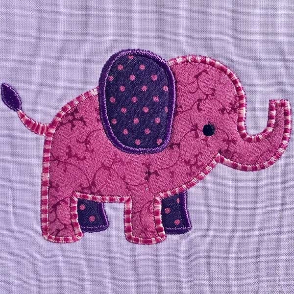 ChristineG_Elephant_VideoThumbnail Pink embroidered elephant applique with purple ear and decorative stitching on lavender fabric.