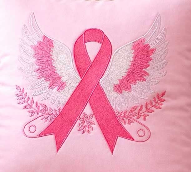 SheilaD_CushionDownload2 1 Pink awareness ribbon with white wings on a pink fabric background, symbolizing breast cancer awareness and hope.