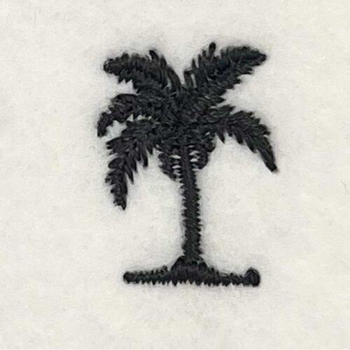 Black palm tree silhouette embroidered on light fabric.