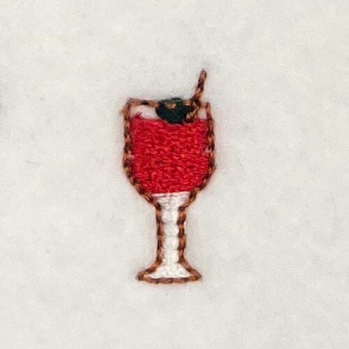 EL_MTC_23 | Embroidery Legacy Embroidered patch depicting a wine glass filled with red wine and a small garnish on a light background