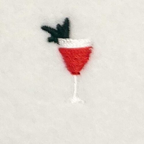 EL_MTC_25 | Embroidery Legacy Illustration of a cocktail glass with a red drink, white rim, and a dark garnish against a light background.