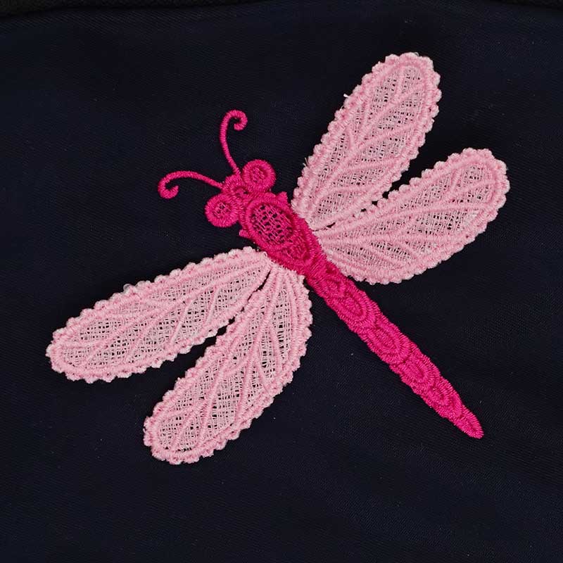 FSL_Dragonfly | Embroidery Legacy Pink lace dragonfly appliqué with delicate wing patterns on a dark fabric background, showing a bright magenta body and pale pink wings.