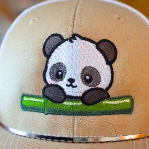 newslett-erPanda-Freebie | Embroidery Legacy Beige baseball cap featuring an embroidered cute panda peeking over a green bamboo stalk.