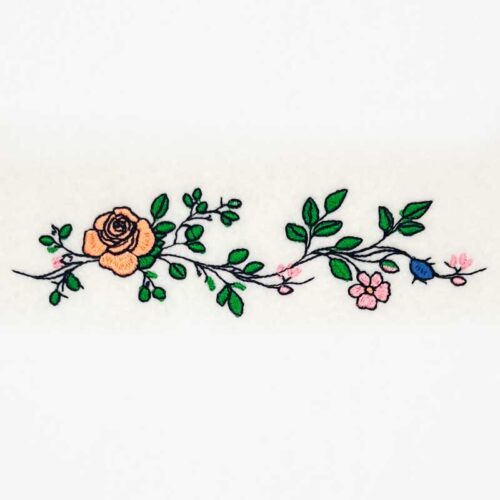 Embroidered floral vine with peach and pink flowers and green leaves on a white background, decorative border design.
