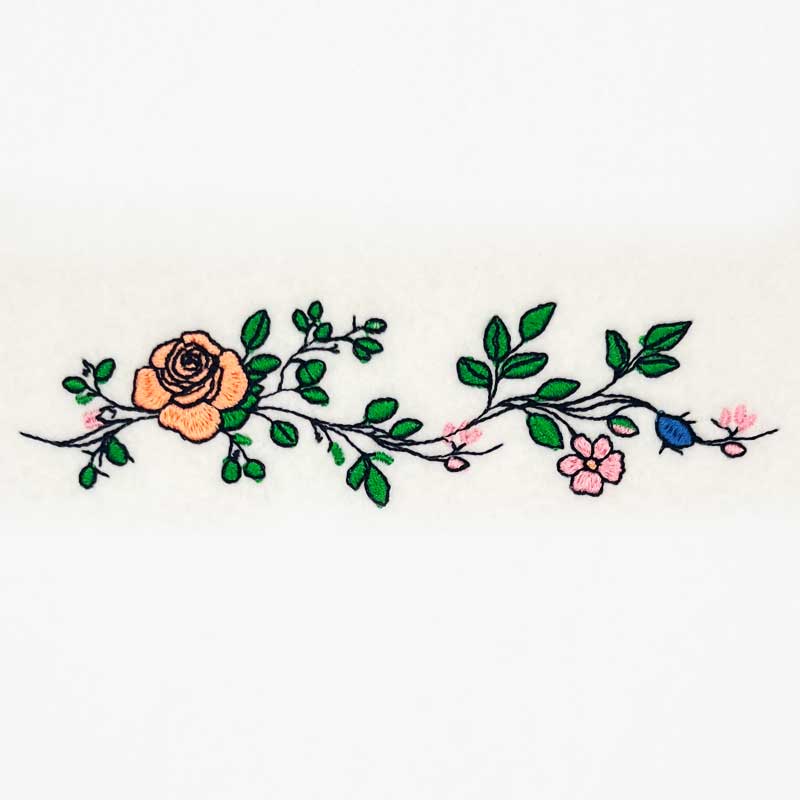 EL_FS4_a | Embroidery Legacy Embroidered floral vine with peach and pink flowers and green leaves on a white background, decorative border design.