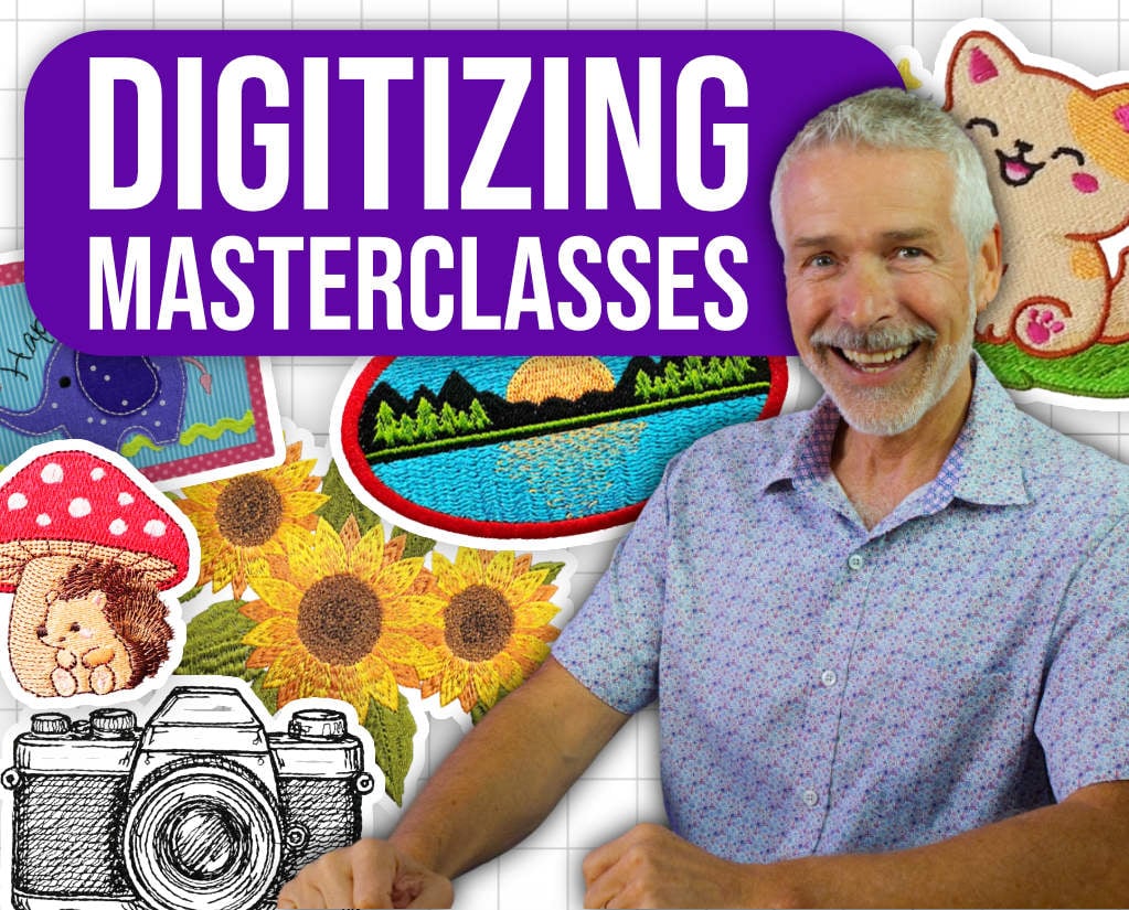 Digtiizing-Master-Class-Machine-Embroidery-Classes Digitizing Masterclasses. John Smiling at camera, various embroidery stitch outs behind him.